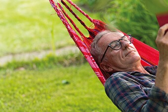 Man resting on a red hammock