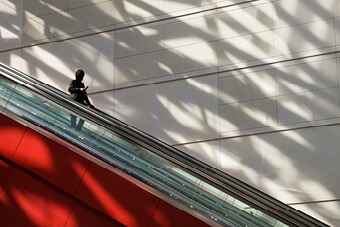 person going down an escalator 