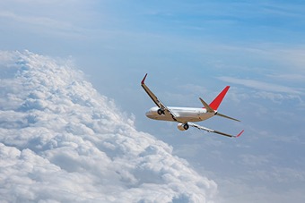 Plane flying against a blue sky