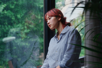 woman looking out window