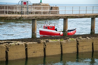 red boat along a pier 