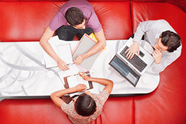 people sat around red table