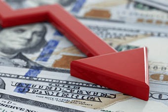 US dollar with red declining arrow overlaid 