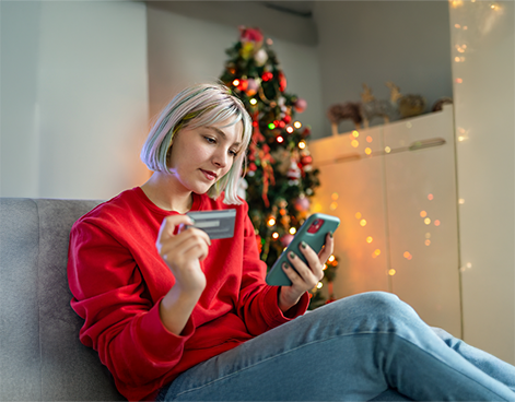Woman typing card details in phone