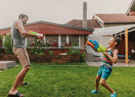 Father and son water fight