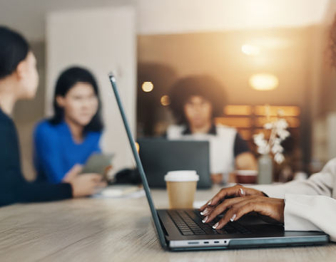 Person typing on laptop in office