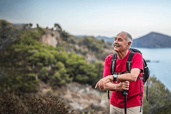 man with red shirt and backpack looking ahead