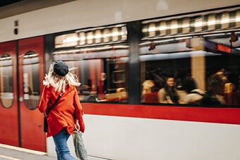 woman running for red train 