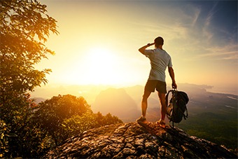 Man with backpack at sunset