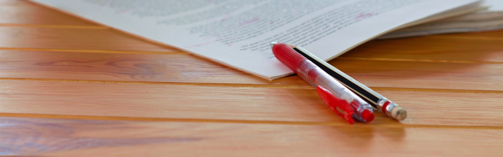 red pen resting on table