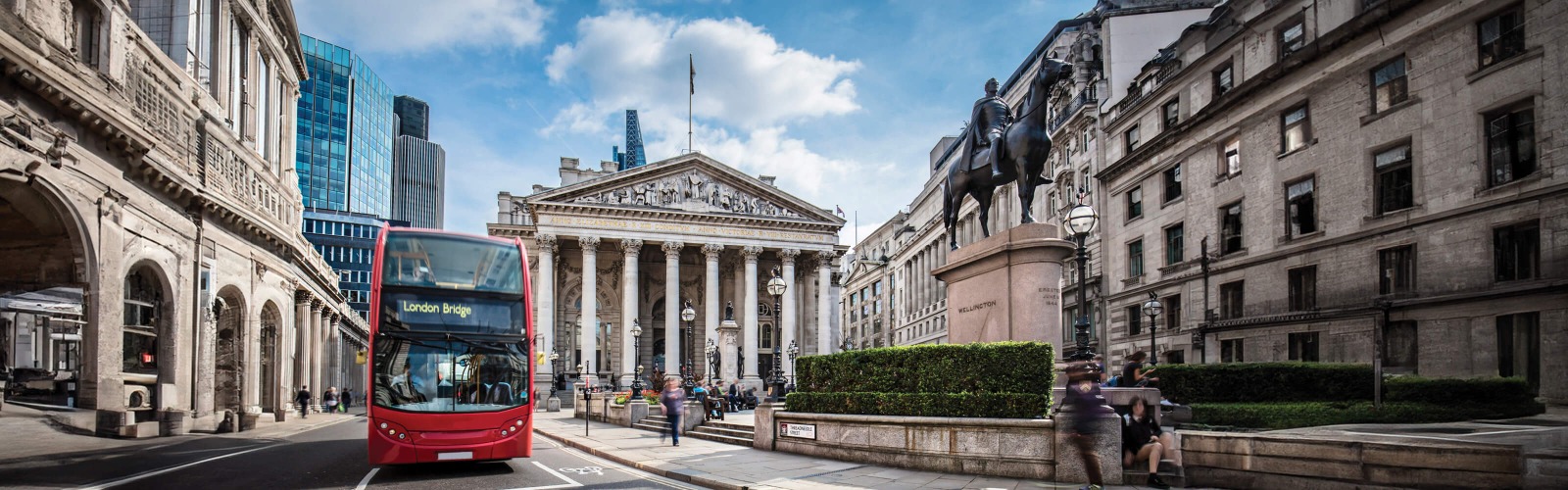 Red bus driving past London landmarks