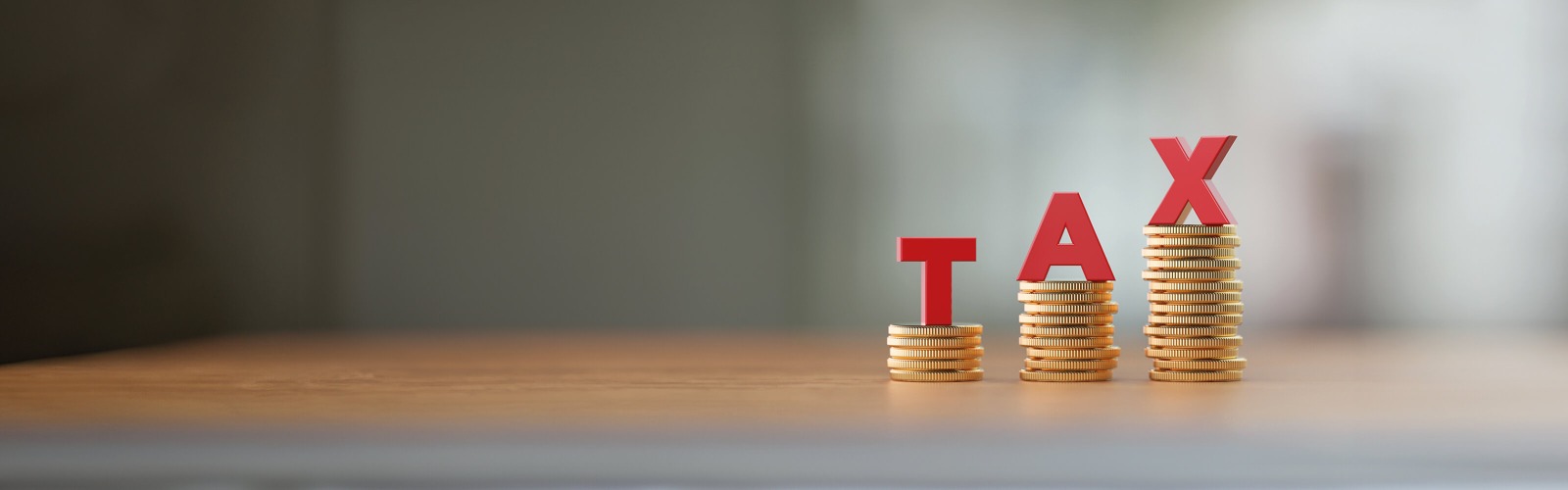 The word tax stacked on coins