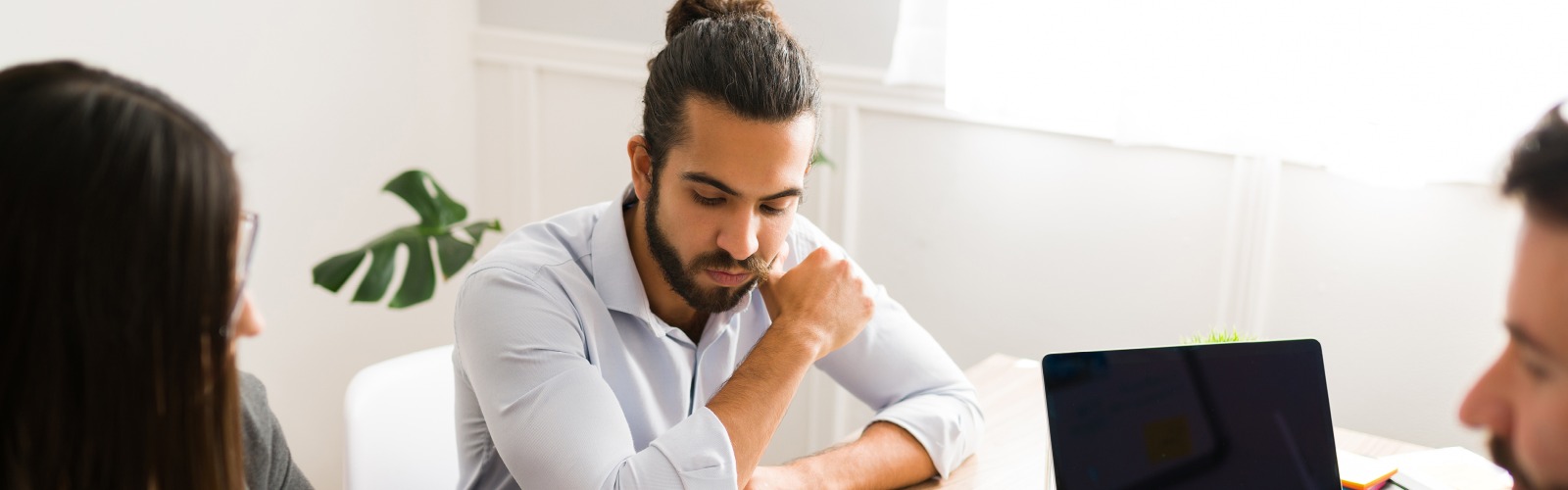 man looking at sheet of paper