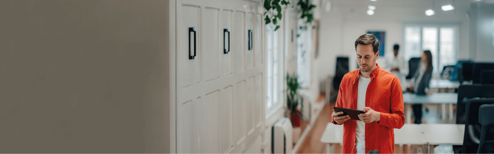 Man in a red shirt stood on a tablet 