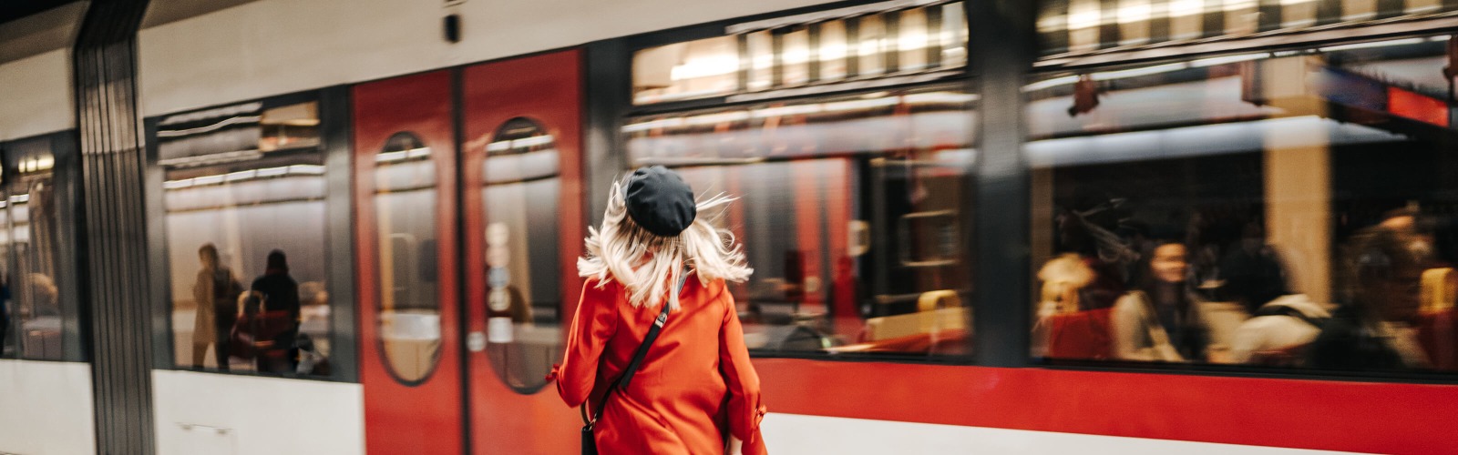 woman running for red train 