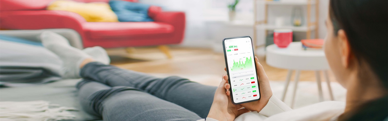 Woman using mobile to invest