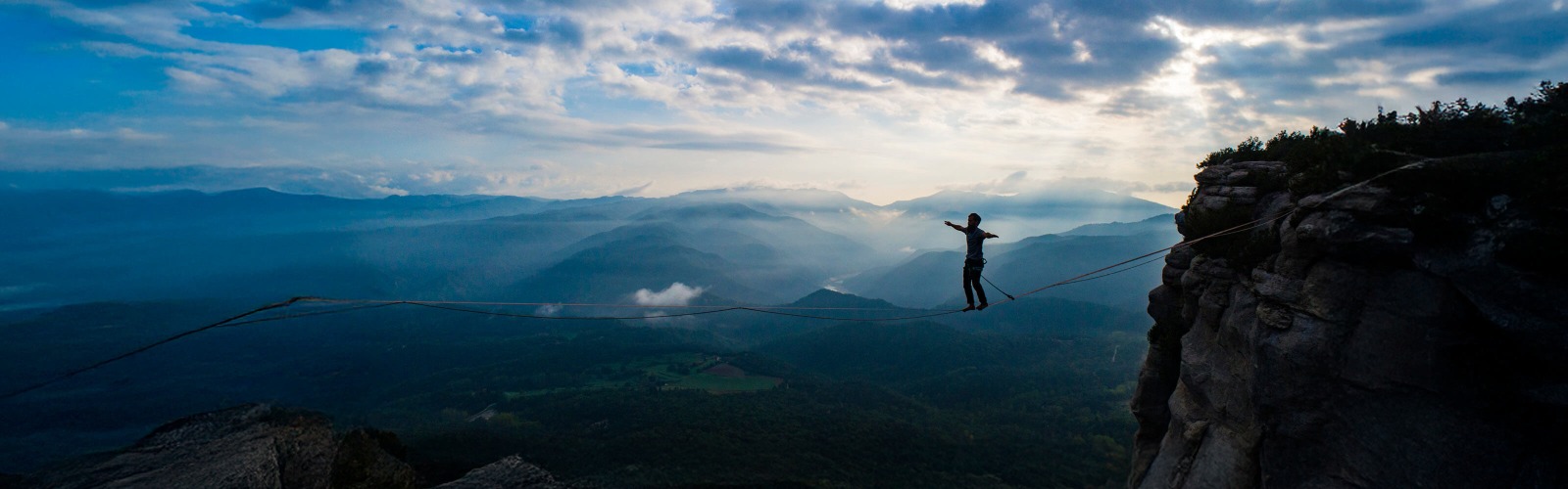 Image of person balancing on a tightrope