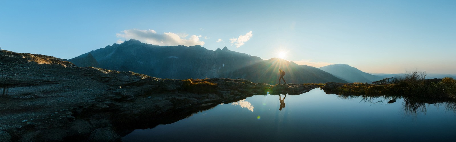 Image of person trekking across mountains