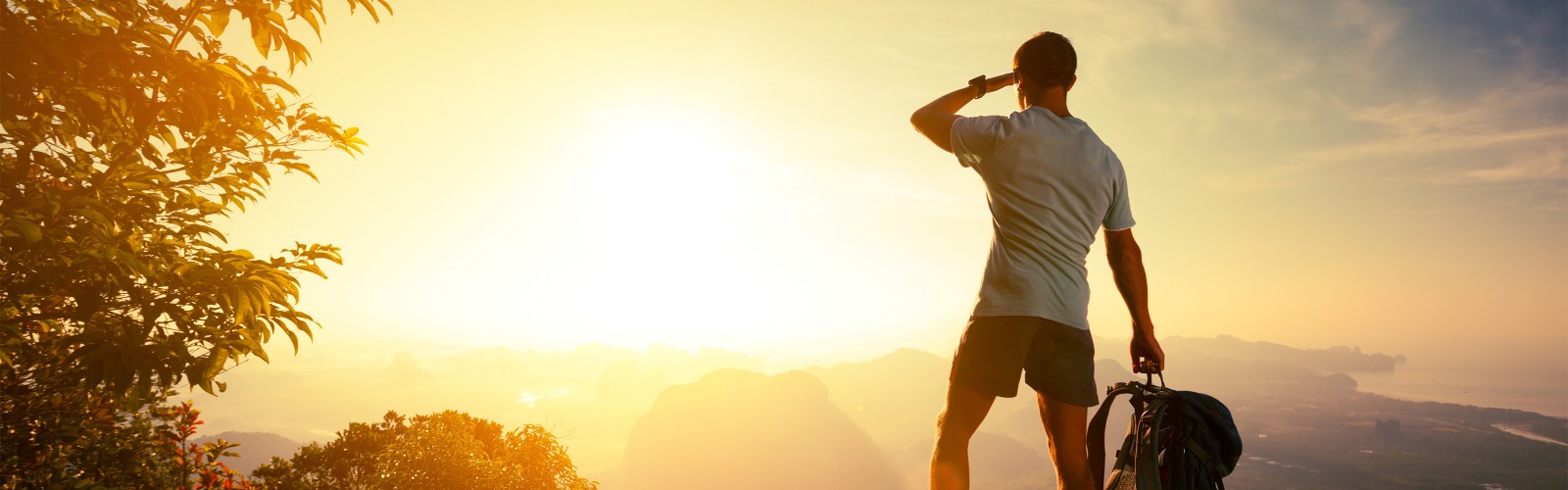 Man with backpack at sunset