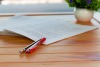 red pen resting on table